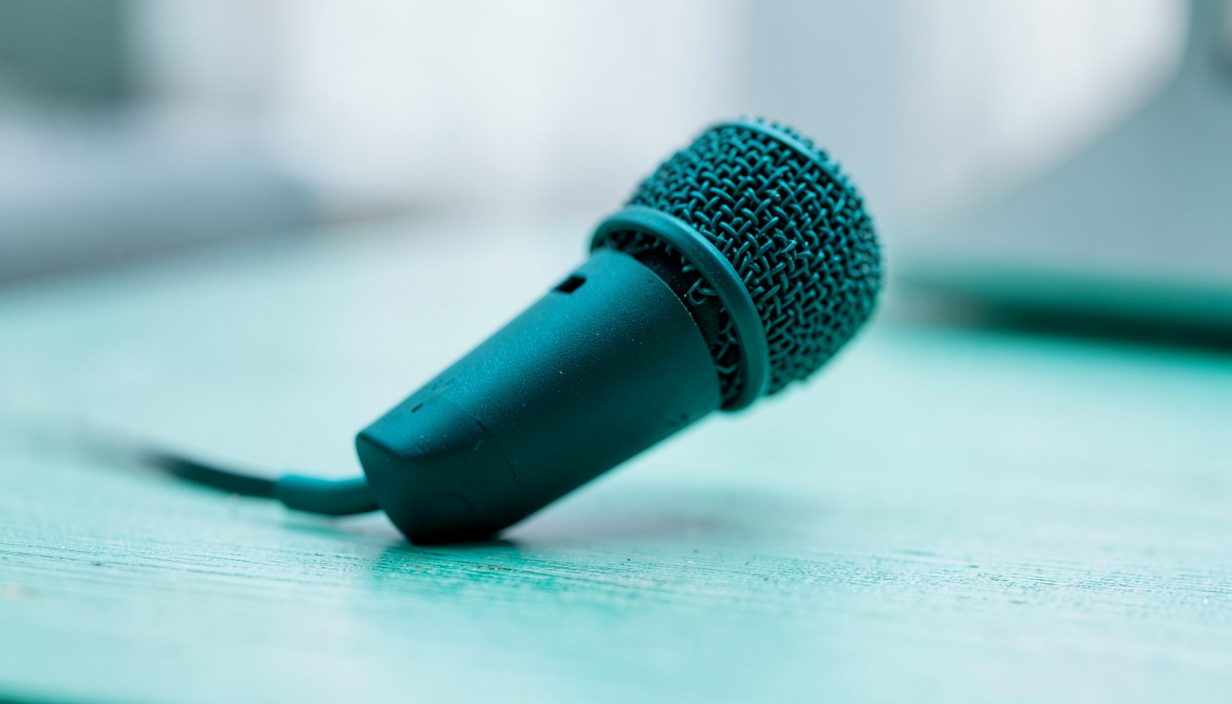Affordable USB microphone on a simple desk setup, clean and minimal